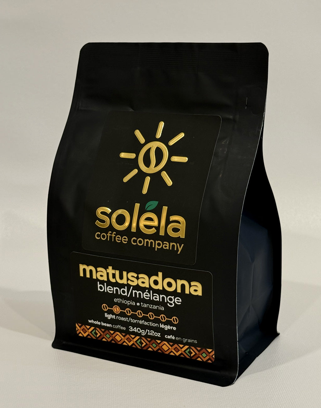 Black coffee bag with Soleéla Coffee Company branding on a light gray background