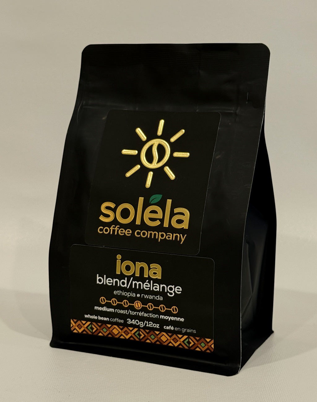 Black coffee bag from Solela Coffee Company with branding and product details on a beige background